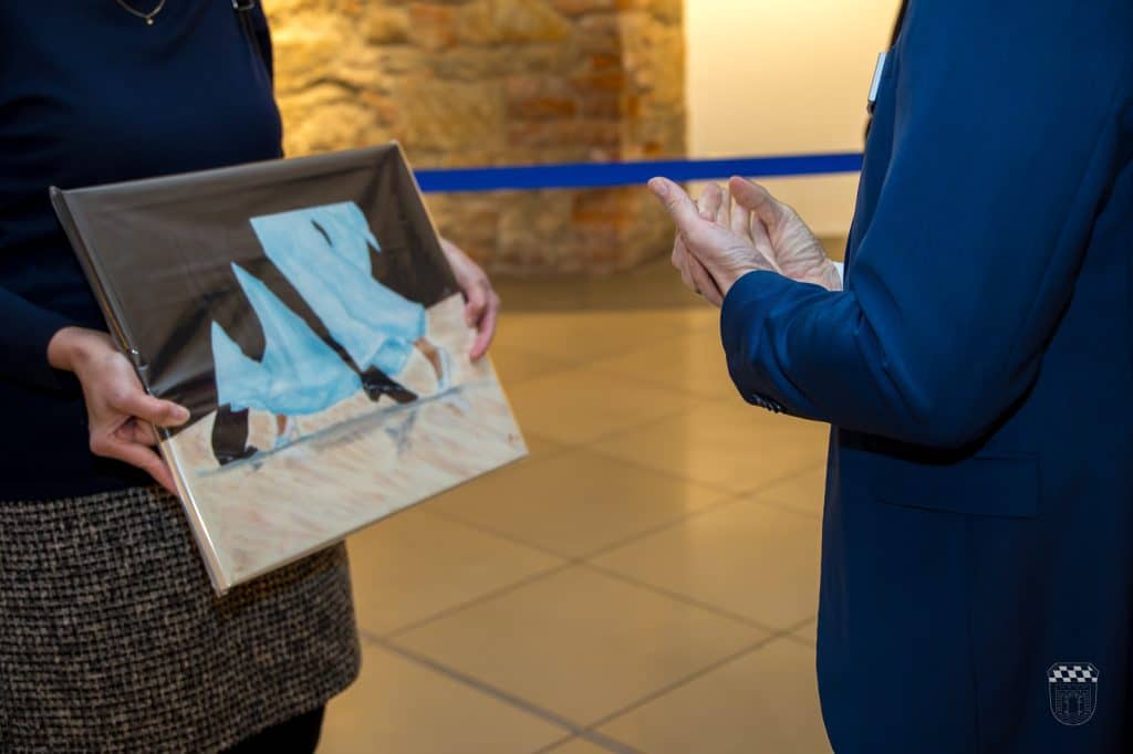 Person shows painting to another