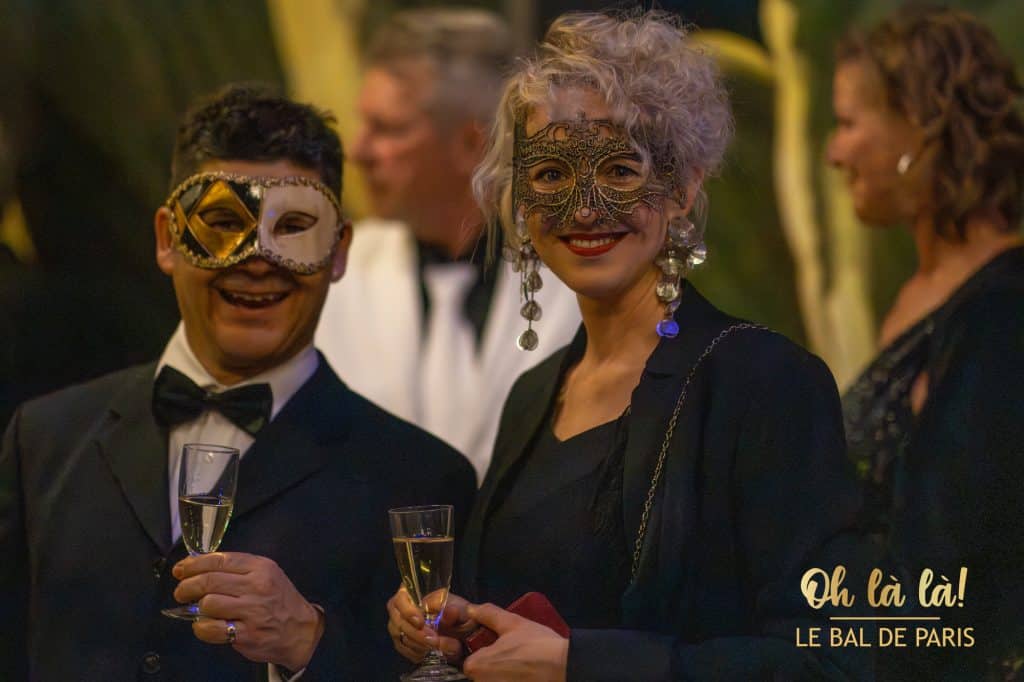 Masked couple with champagne